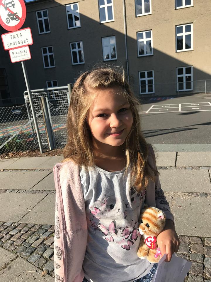 Aria standing in front of her new school