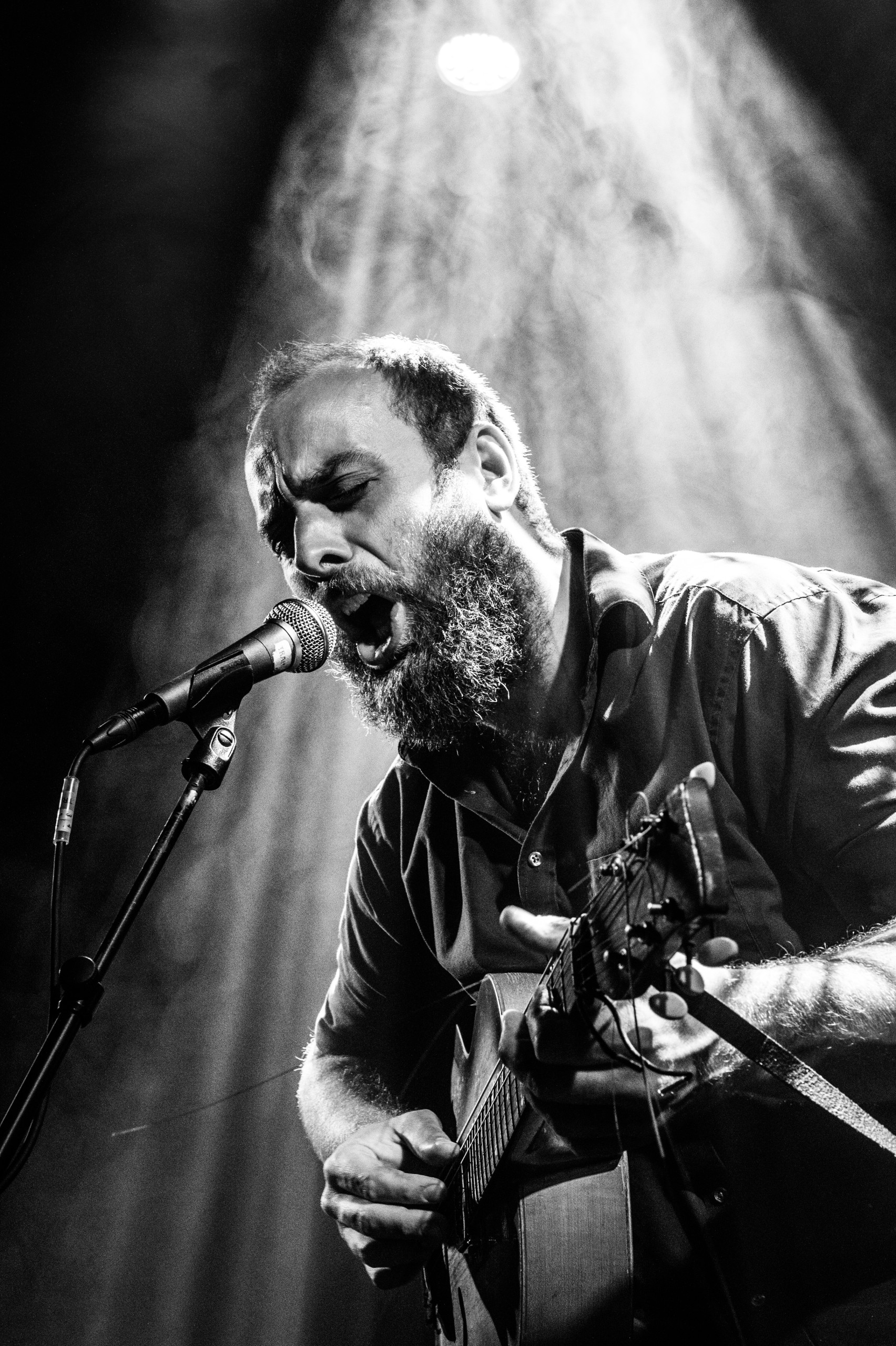 Music artist singing and playing a guitar