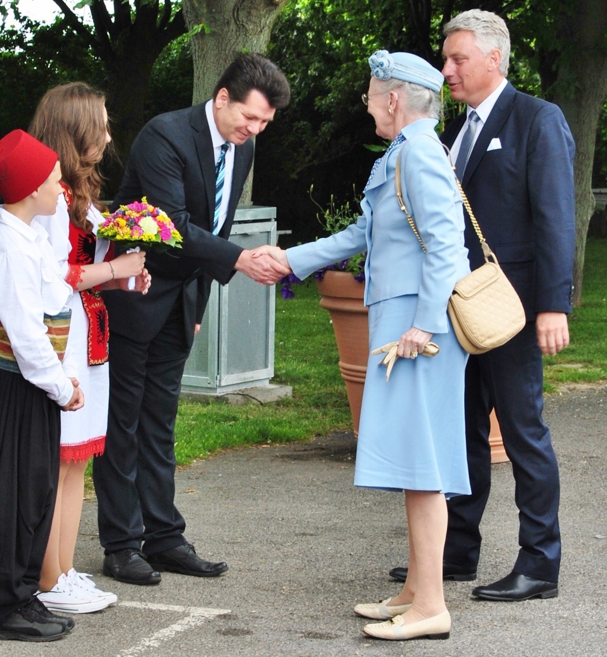 Man and a woman shaking hands while the man bows