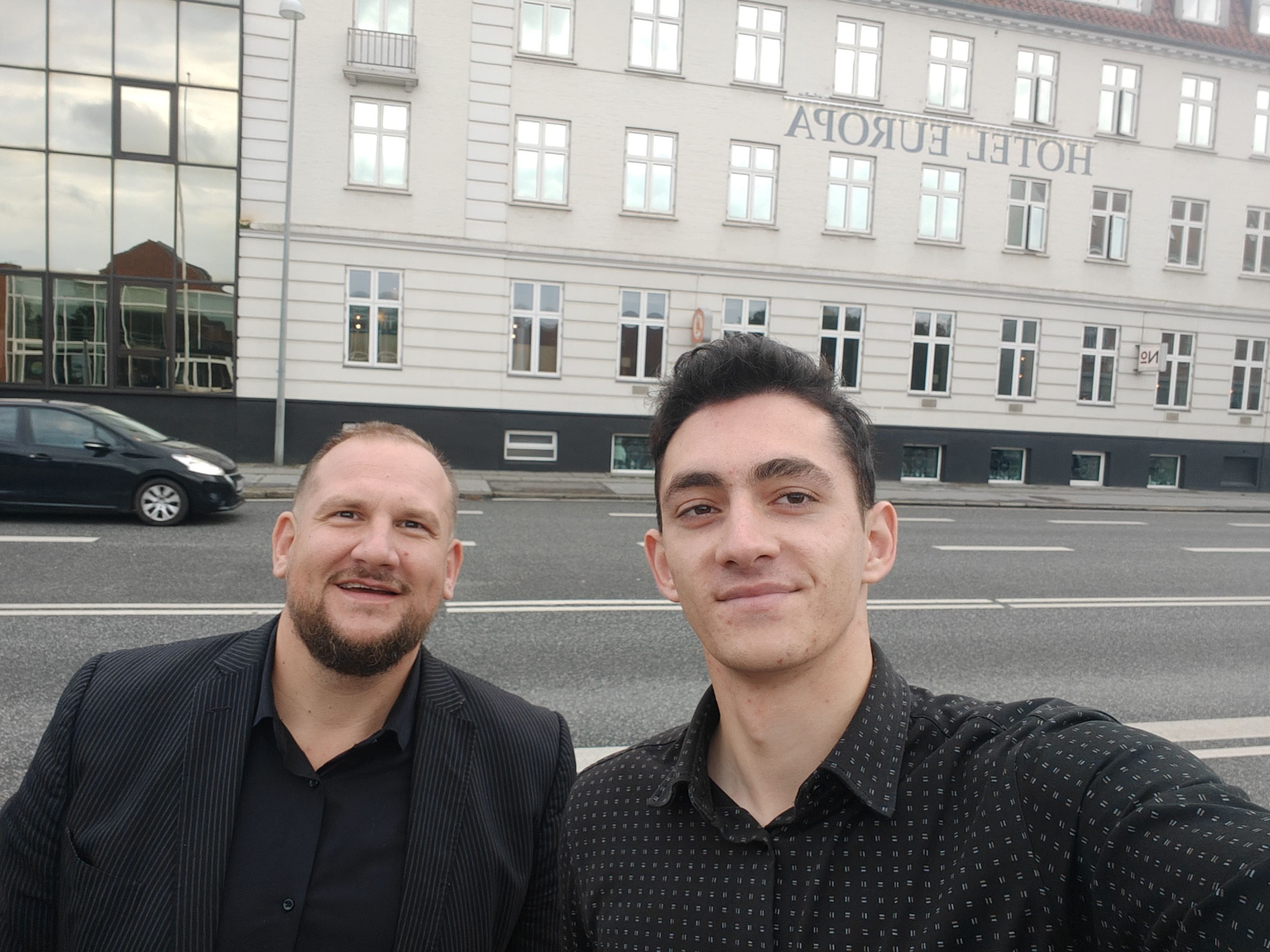 Selfie of 2 men in black shirts