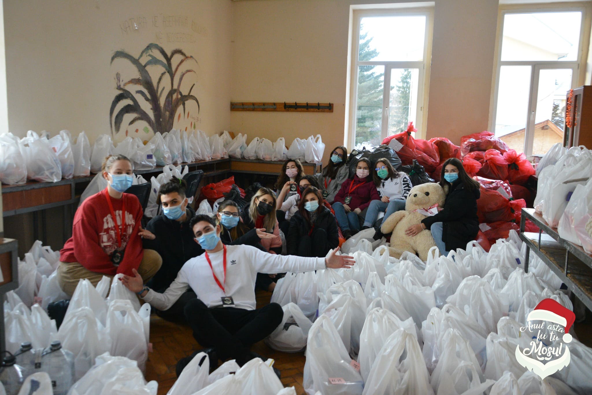 People sitting among white bags in a room