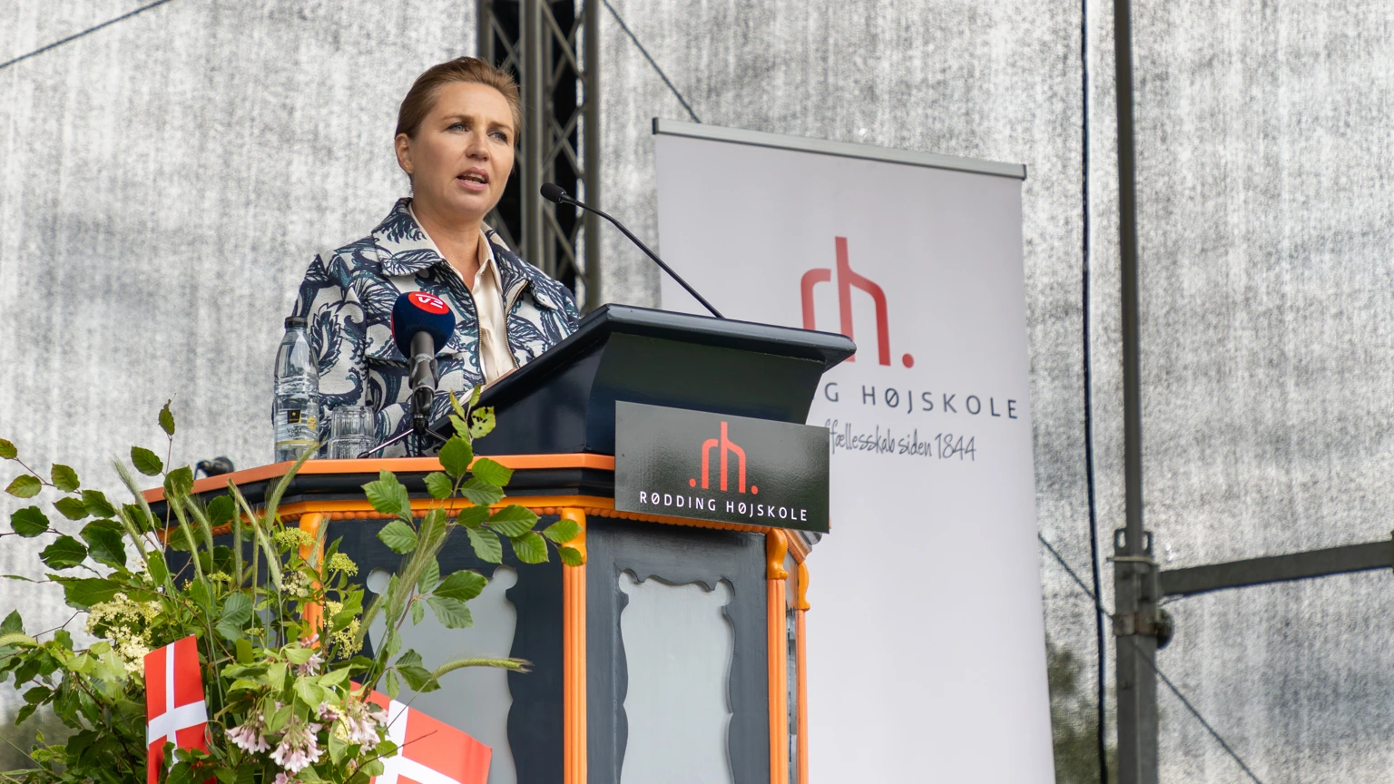 Woman speaking on a microphone