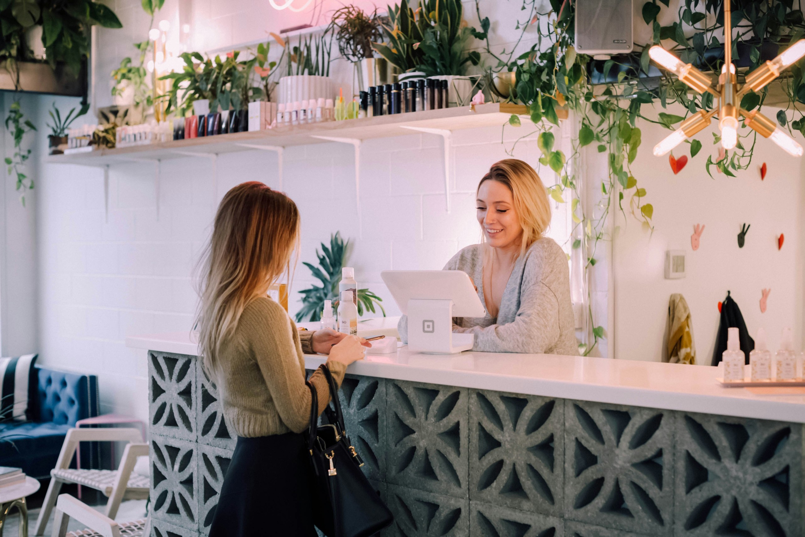 Woman interacting with a cashier. 