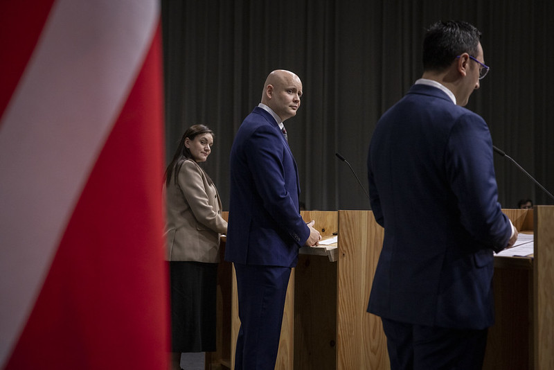 A man in suit stands at a podium