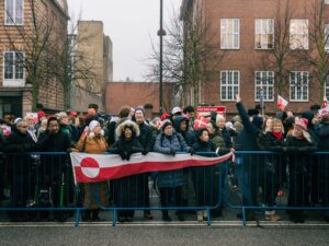 Protesters hold Greenland flag Group of protesters hold Greenland flag