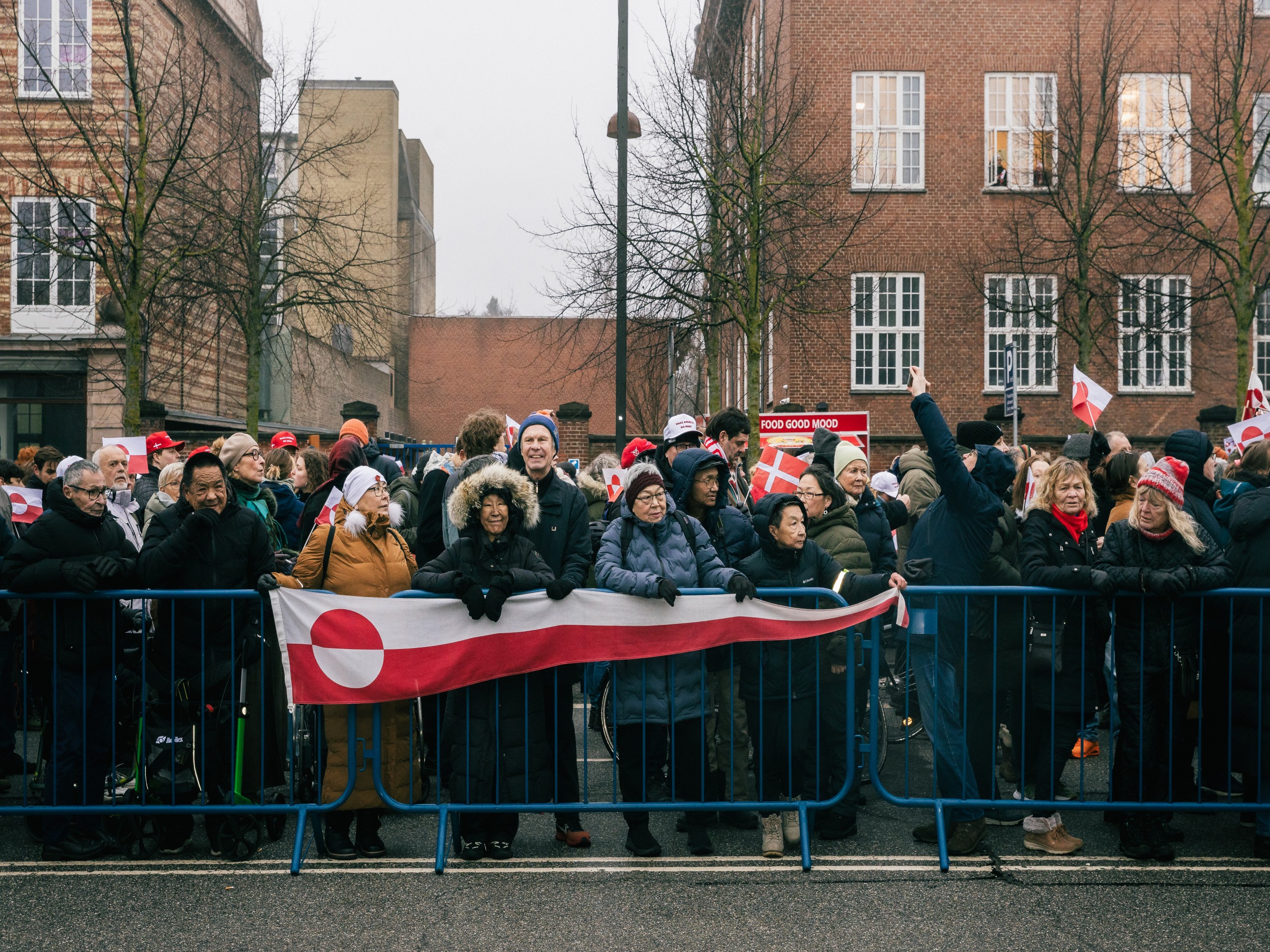 Group of protesters hold Greenland flag