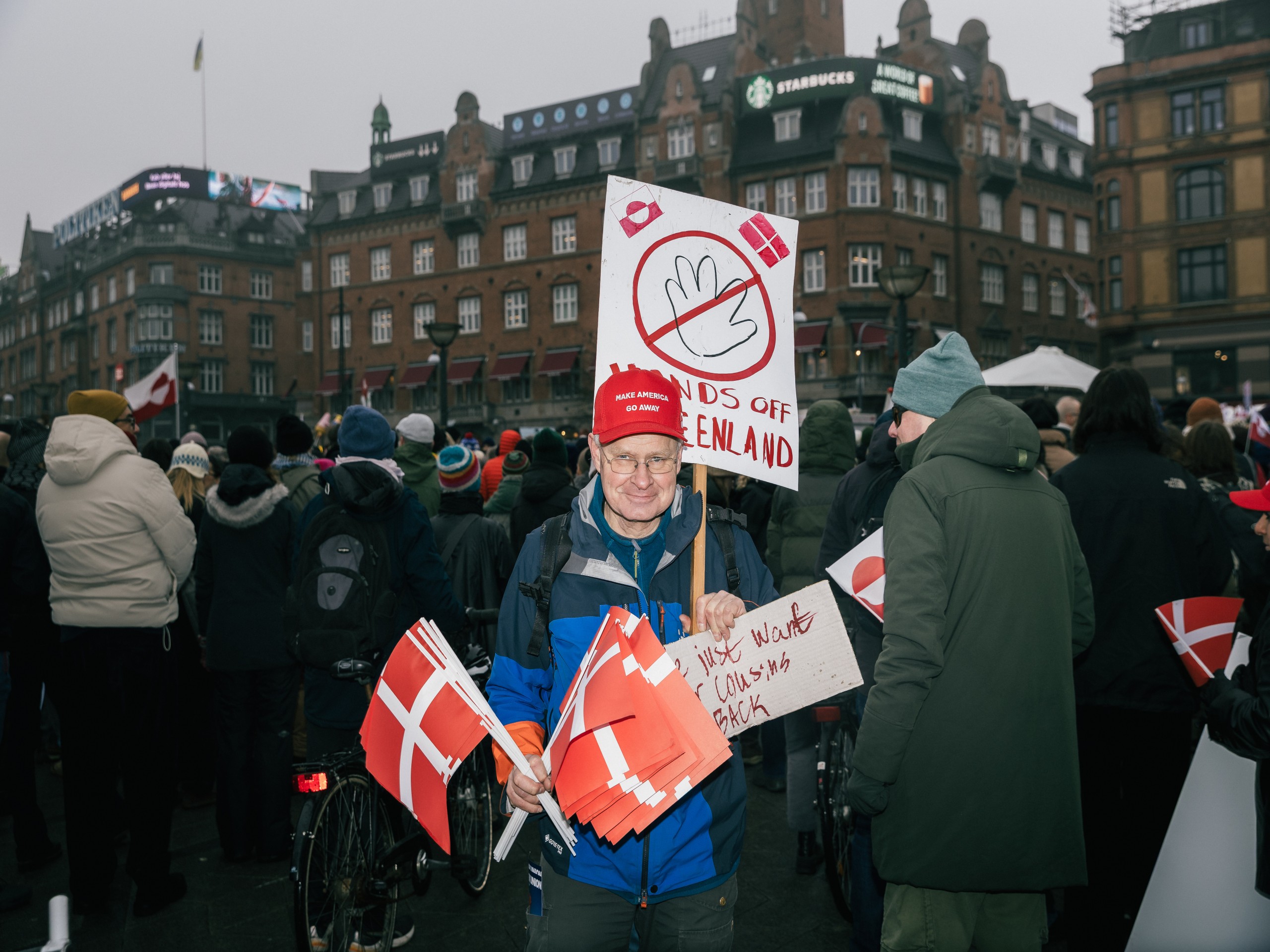 A man handing out Danish flags