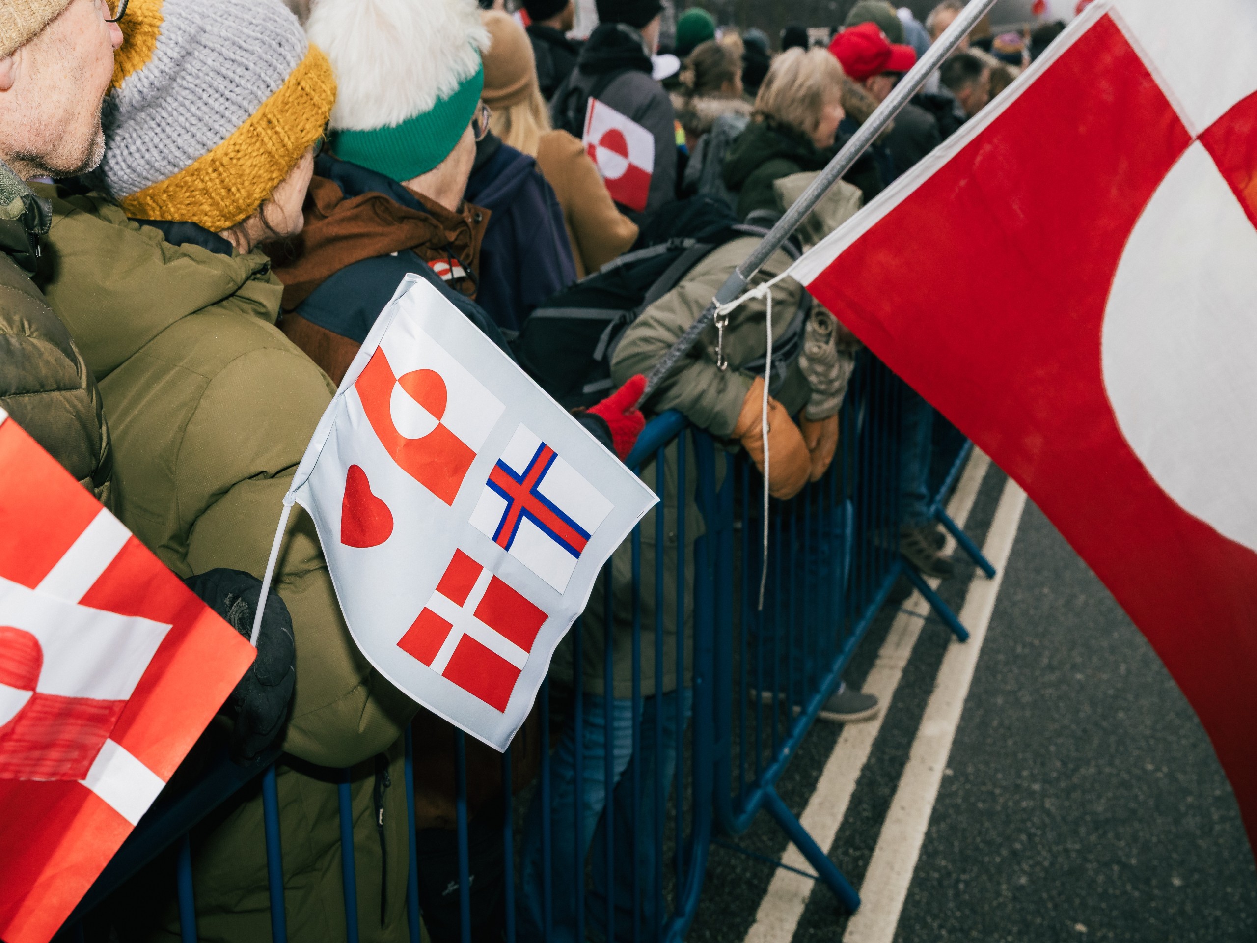 People holding different flags with the focus on flags