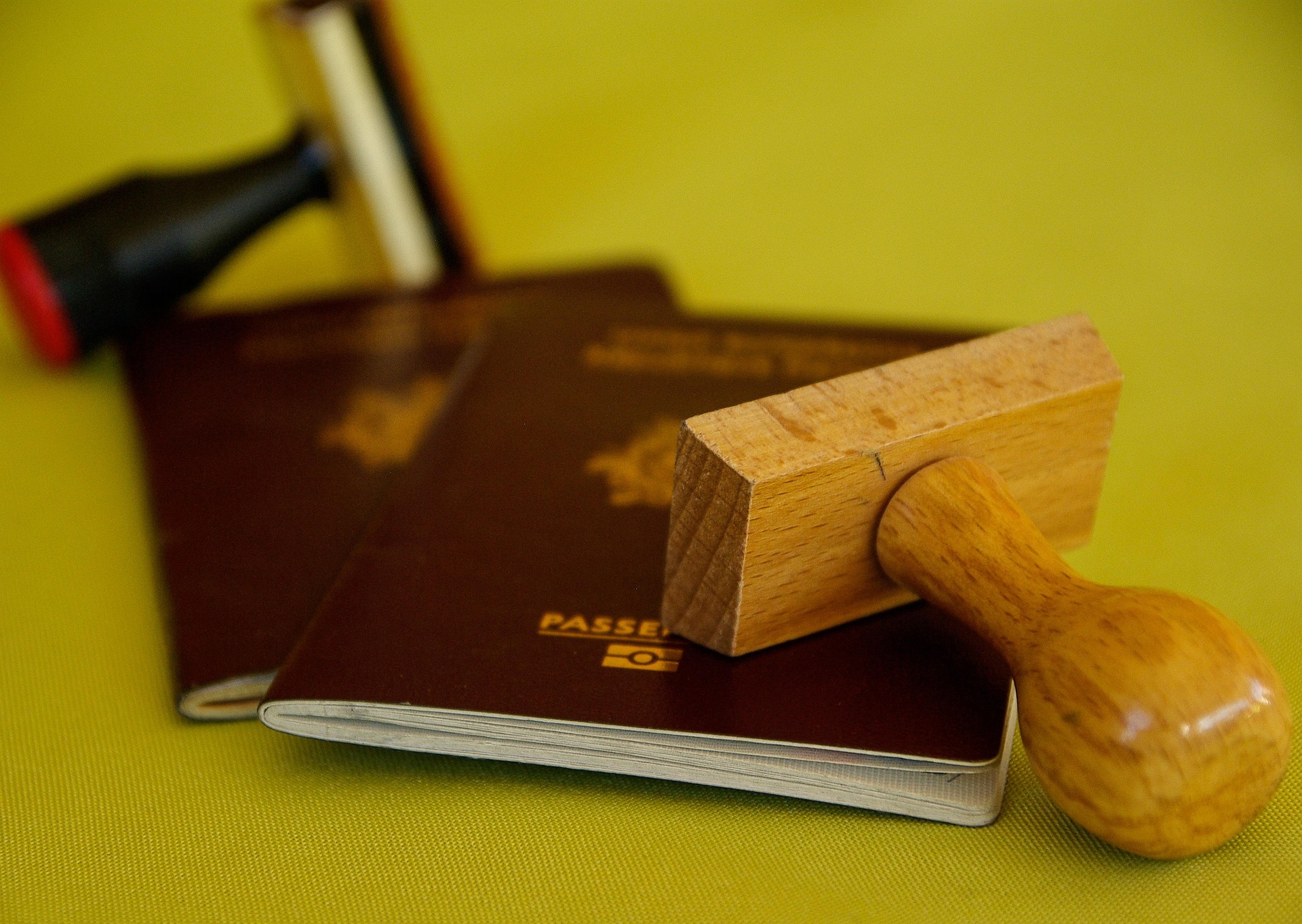 Featured image Passport Image of 2 red passports on a yellow background