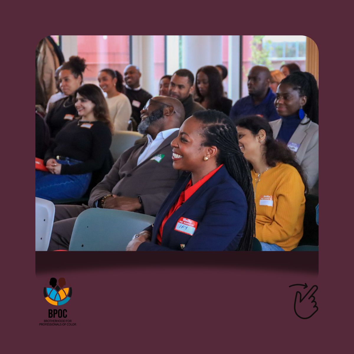 Seated people laughing while at a event