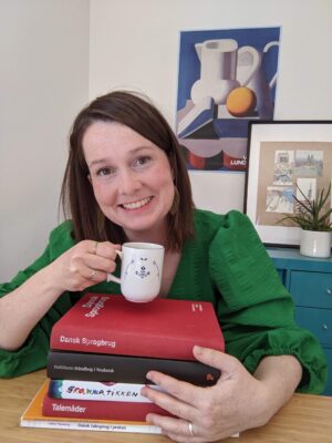 Daniela posing Daniela with Dansk books