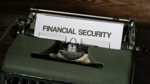 Financial security typed on a vintage typewriter Close-up of a dark green vintage typewriter with a sheet of paper reading 'FINANCIAL SECURITY' in bold capitals.